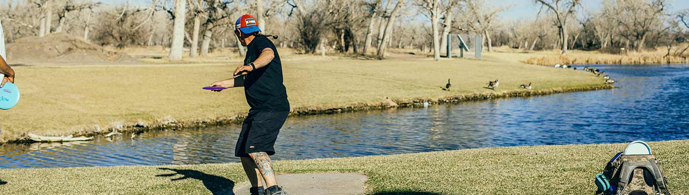 teeing off at a disc golf course in morgan county, co